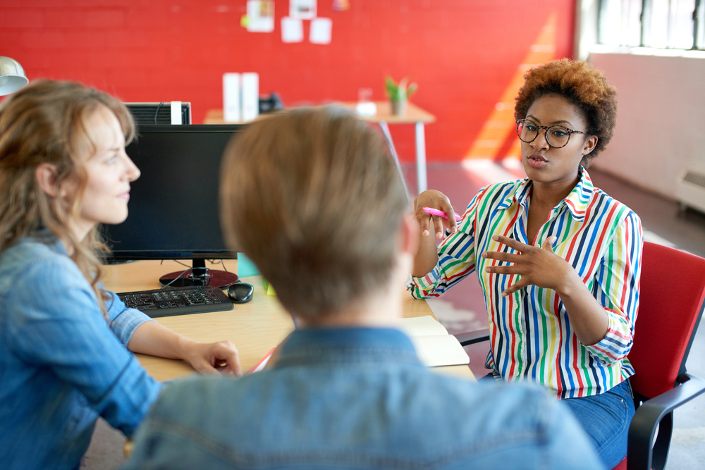 Unposed group of creative business people in an open concept office brainstorming their next project.-Aug-02-2024-06-13-03-7565-PM