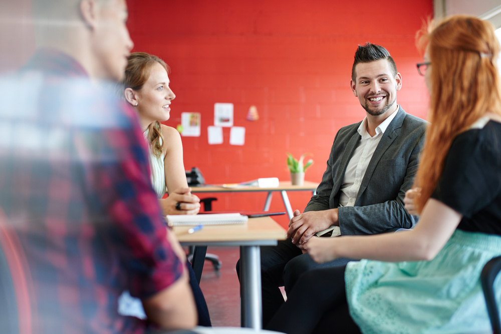 Unposed group of creative business people in an open concept office brainstorming their next project.-Aug-27-2024-08-01-51-0353-PM